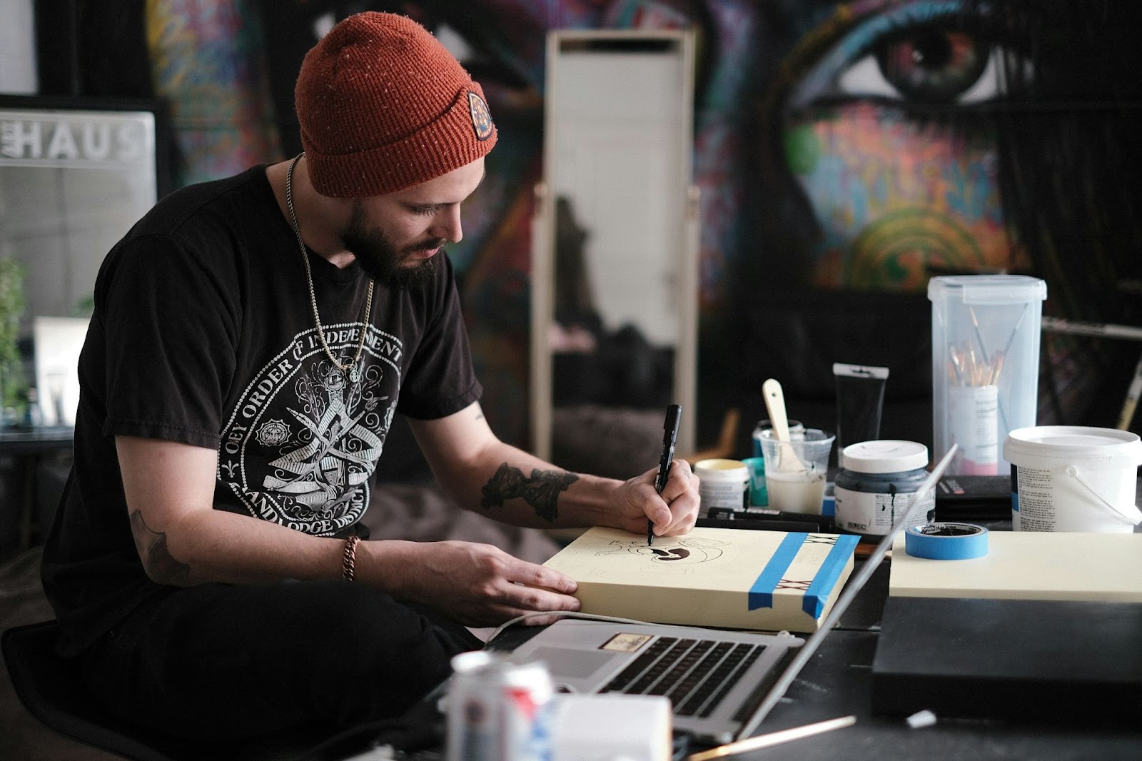 Make money as an Independent Artist - An artist drawing with his laptop open